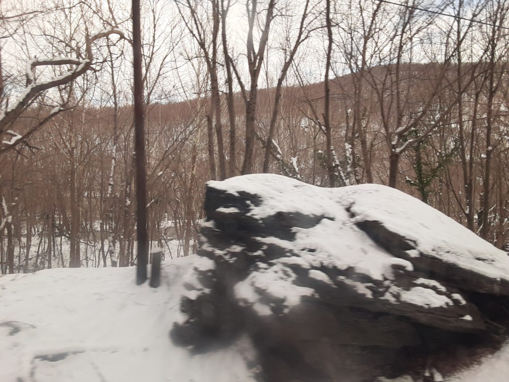 A boulder on the side of the tracks