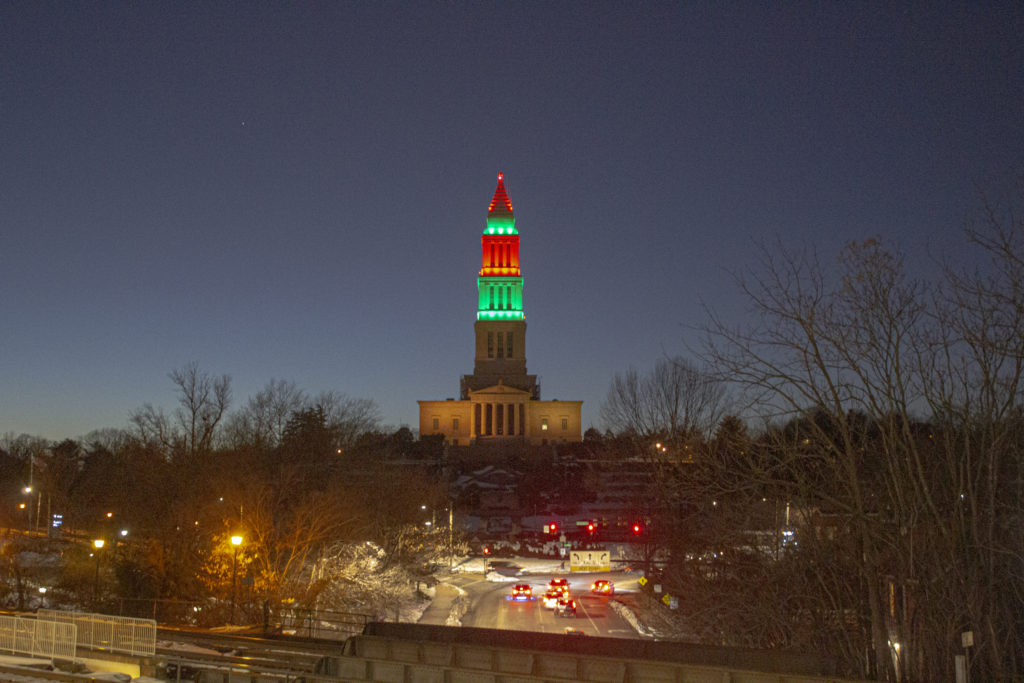 The George Washington Masonic National Memorial lit up red and green